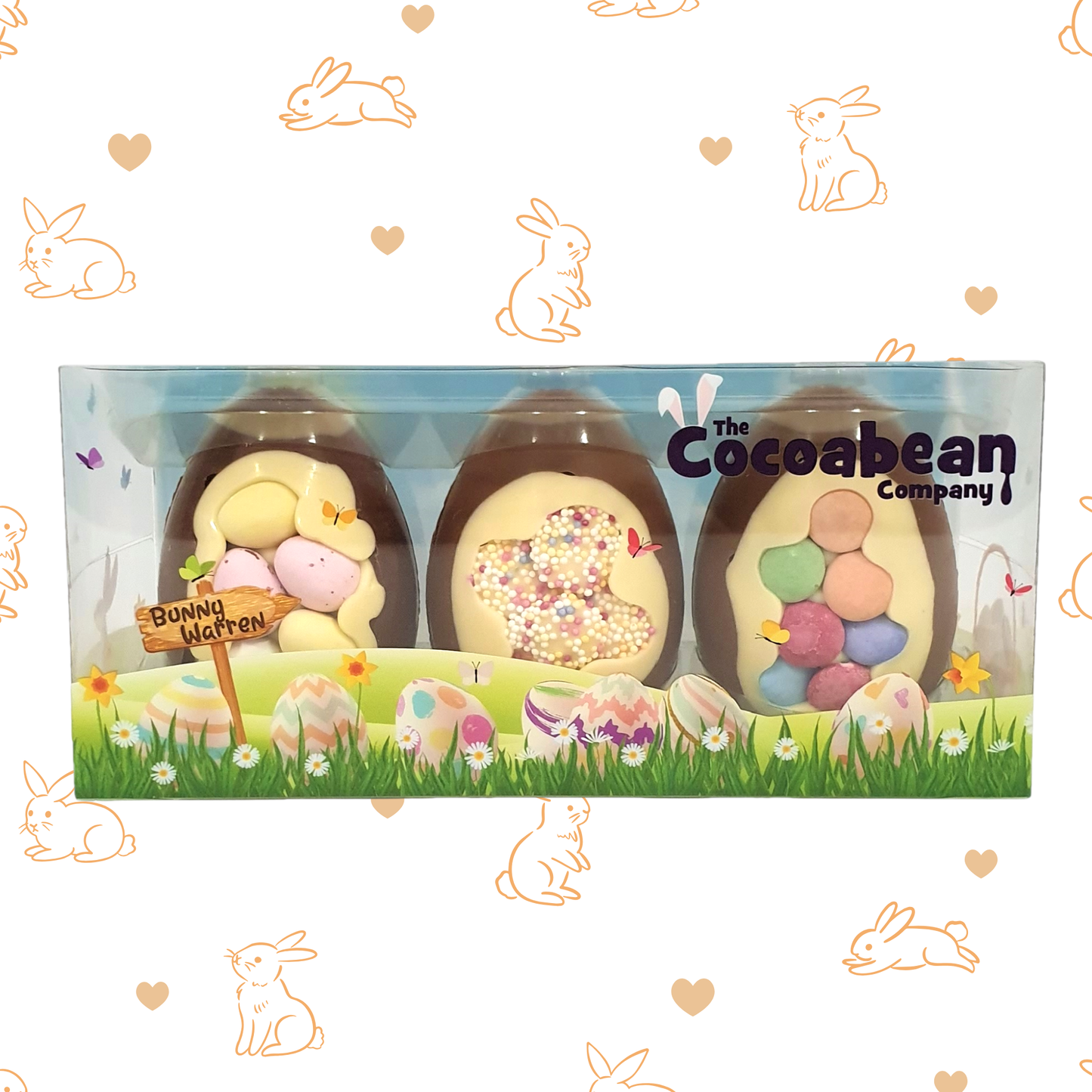 Easter egg-shaped treats in a box with 'The Cocoabean Company' branding, surrounded by Easter-themed illustrations.