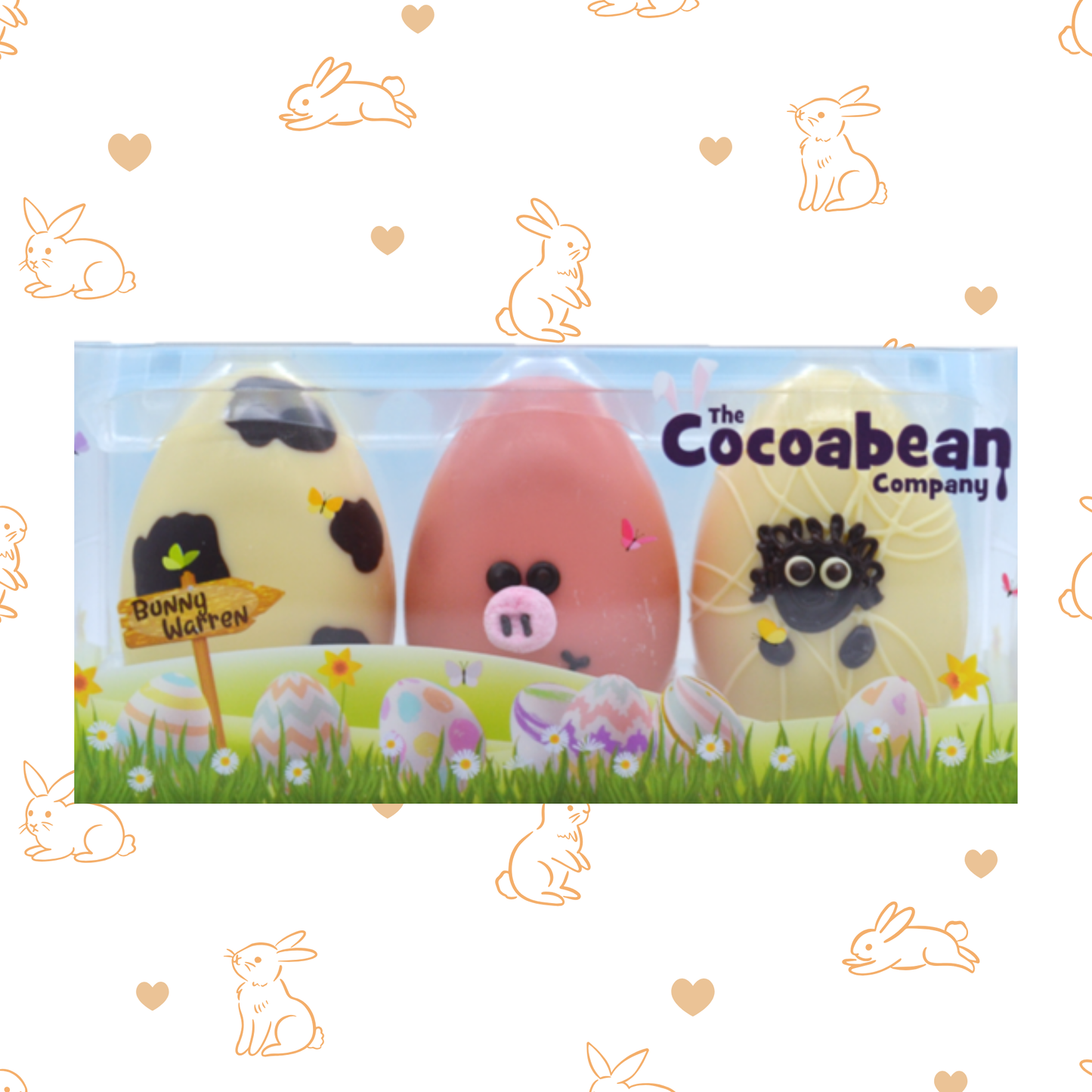 Easter-themed chocolate eggs with animal faces in a box, branded 'The Cocoabean Company', on a decorative background with bunnies and hearts.