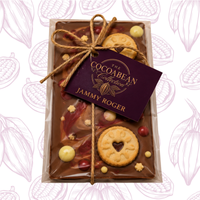 milk chocolate bar with mini jammy dodgers and white chocolate pieces on decorative background