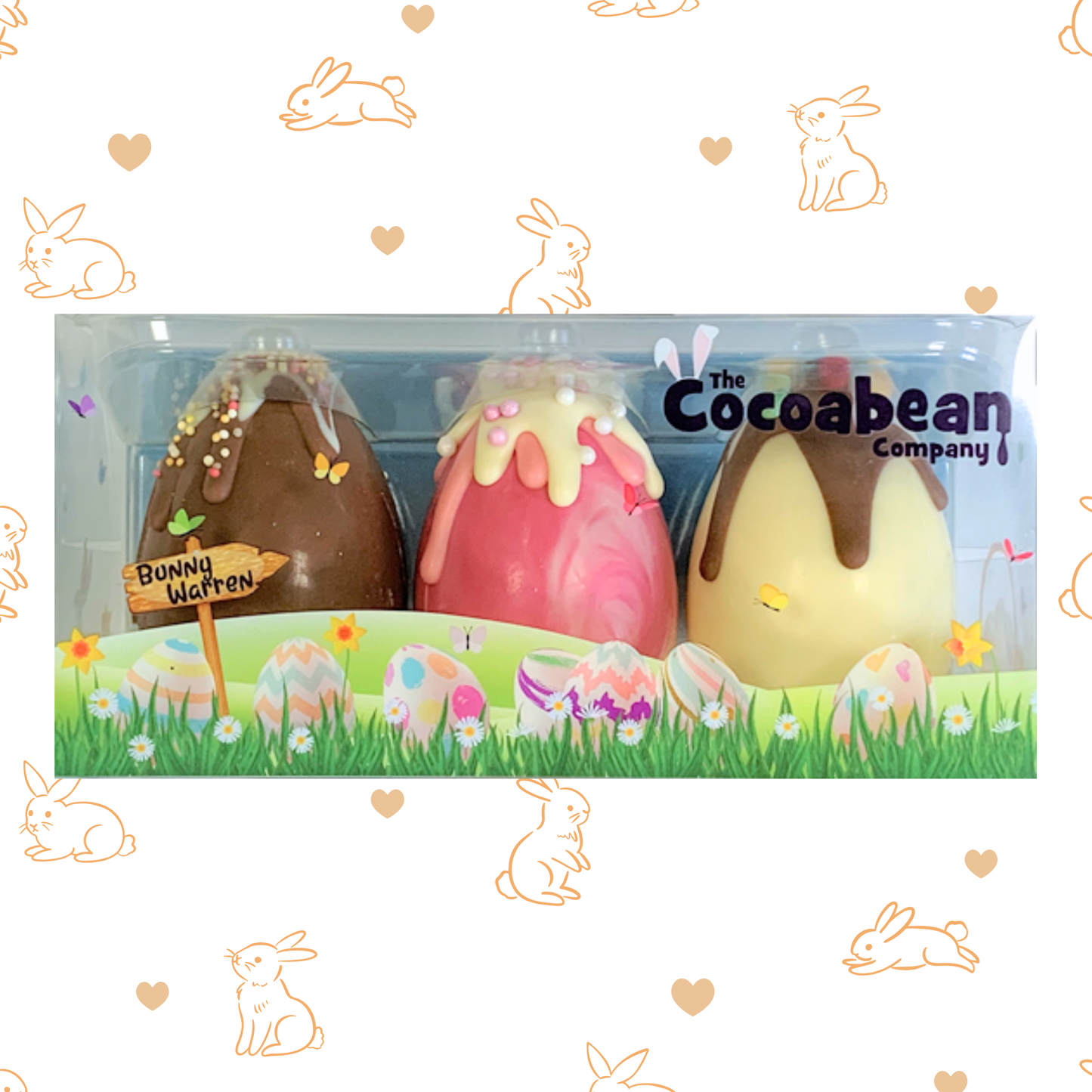 Easter-themed chocolate eggs in a clear packaging with 'The Cocoabean Company' branding, surrounded by decorative elements.