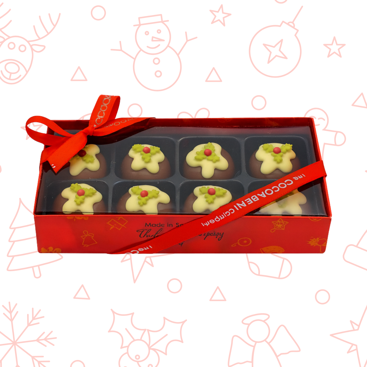 Box of Christmas pudding themed chocolates with a red ribbon on a festive background